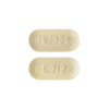 two Percoocet 10/325mg pills with numbers and letters